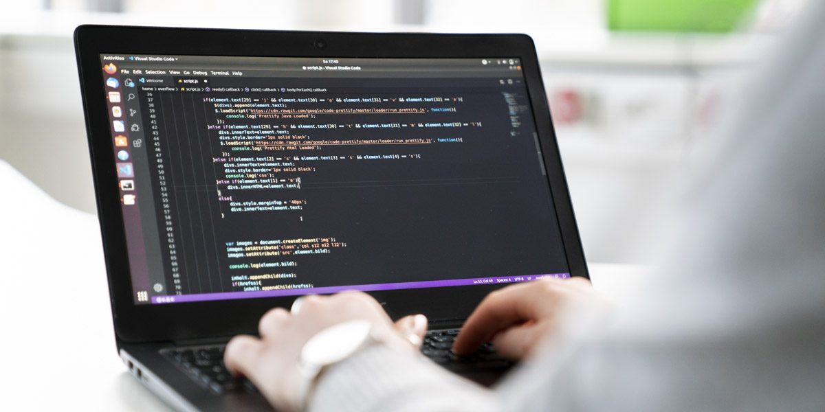 Person programmiert an einem Laptop in Visual Studio Code