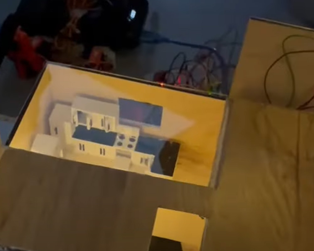 Eine Draufsicht auf die beleuchtete Küche in einem Hausmodell.